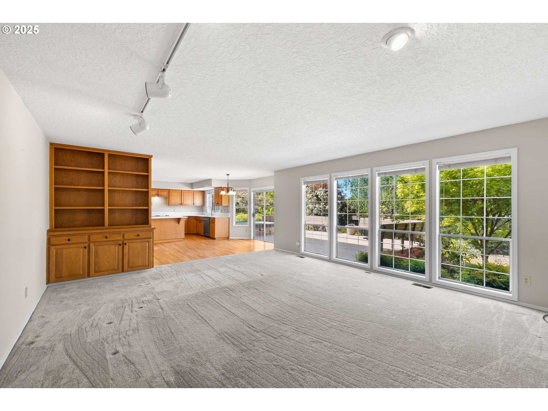 5393 Southwest Wichita Street Tualatin, OR 97062 - Photo 21 of 45 a view of an empty room with a window and wooden floor