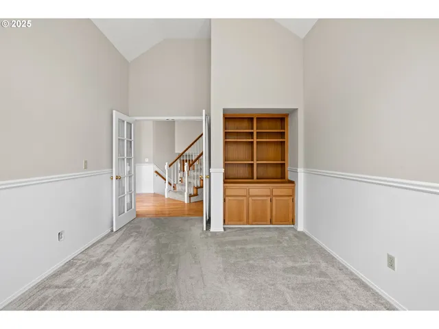 a view of an empty room with stairs and ventilation