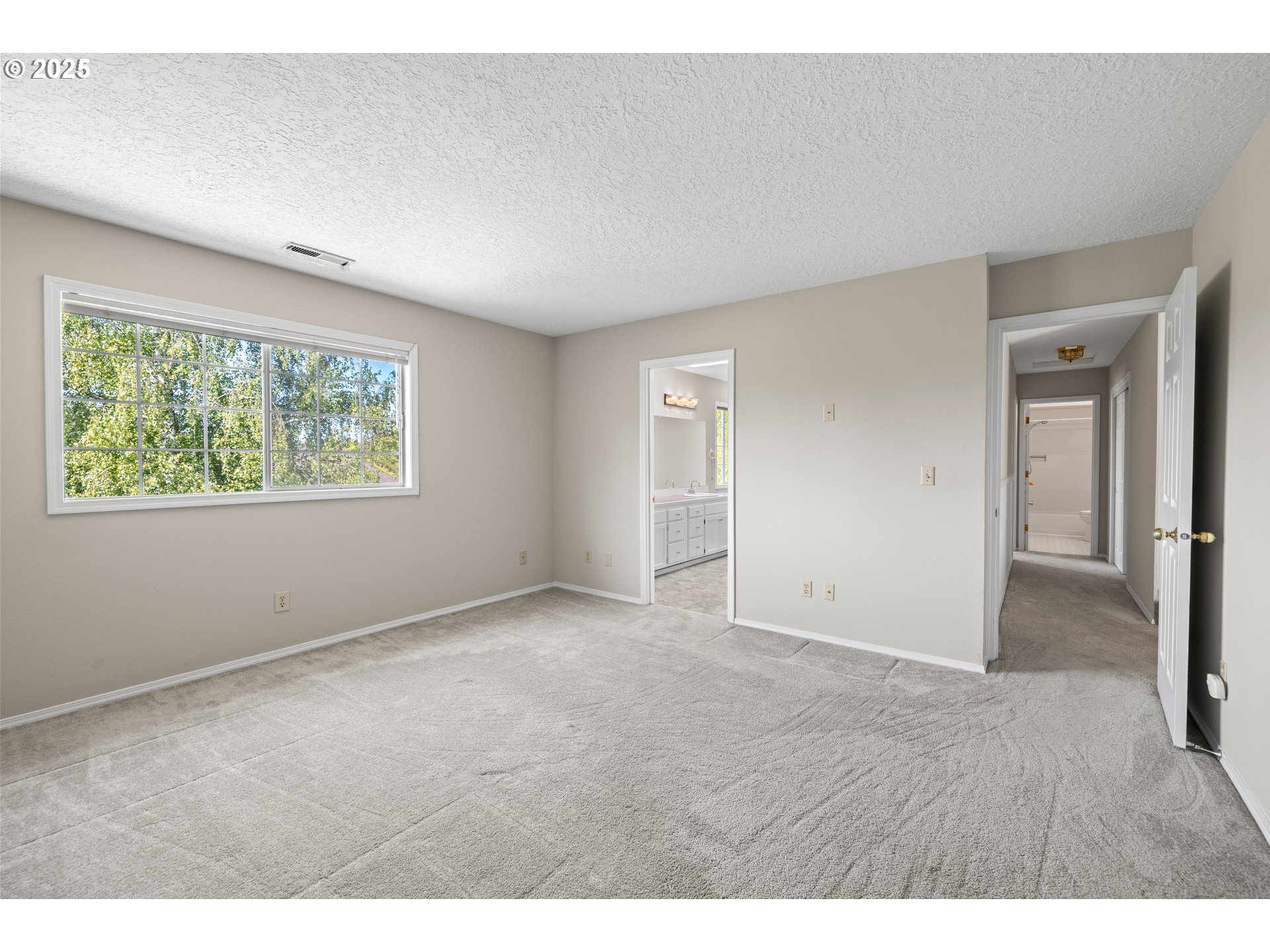 5393 Southwest Wichita Street Tualatin, OR 97062 - Photo 28 of 45 a view of an empty room with wooden floor and a window