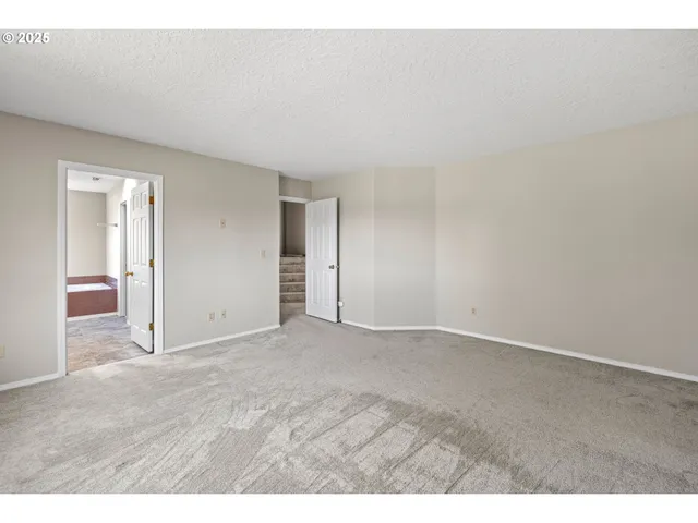 a view of an empty room and wooden floor