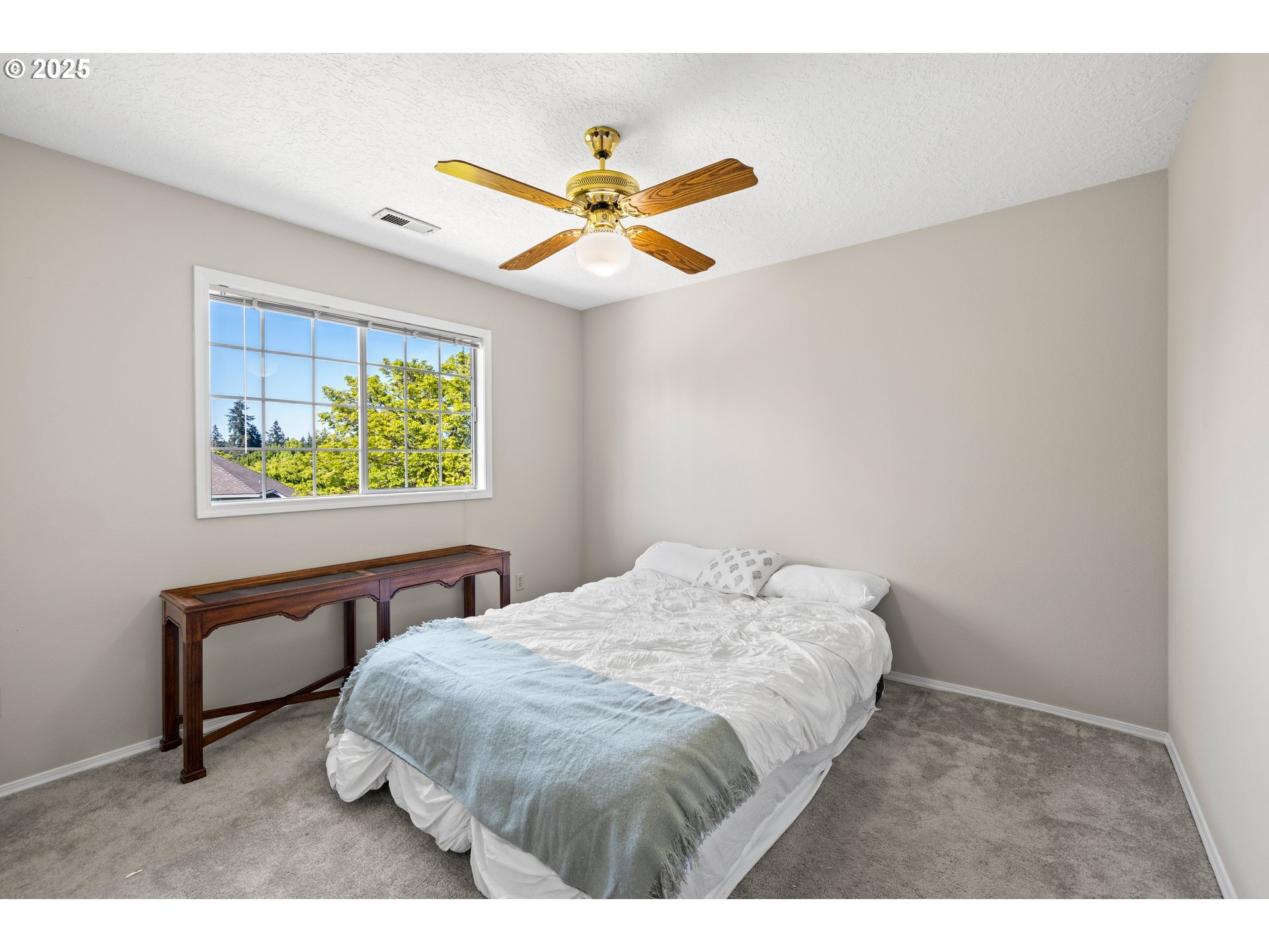 5393 Southwest Wichita Street Tualatin, OR 97062 - Photo 33 of 45 a bedroom with a bed and a chandelier