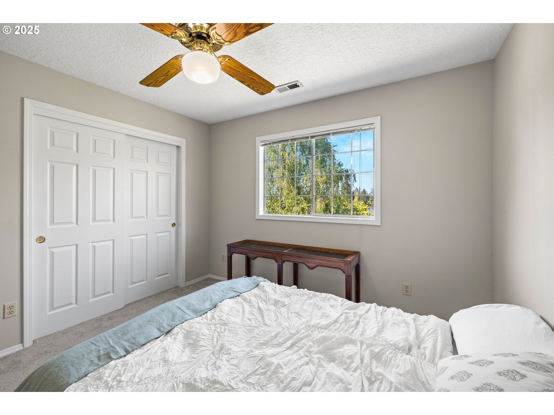 5393 Southwest Wichita Street Tualatin, OR 97062 - Photo 34 of 45 a bedroom with a bed and a chandelier