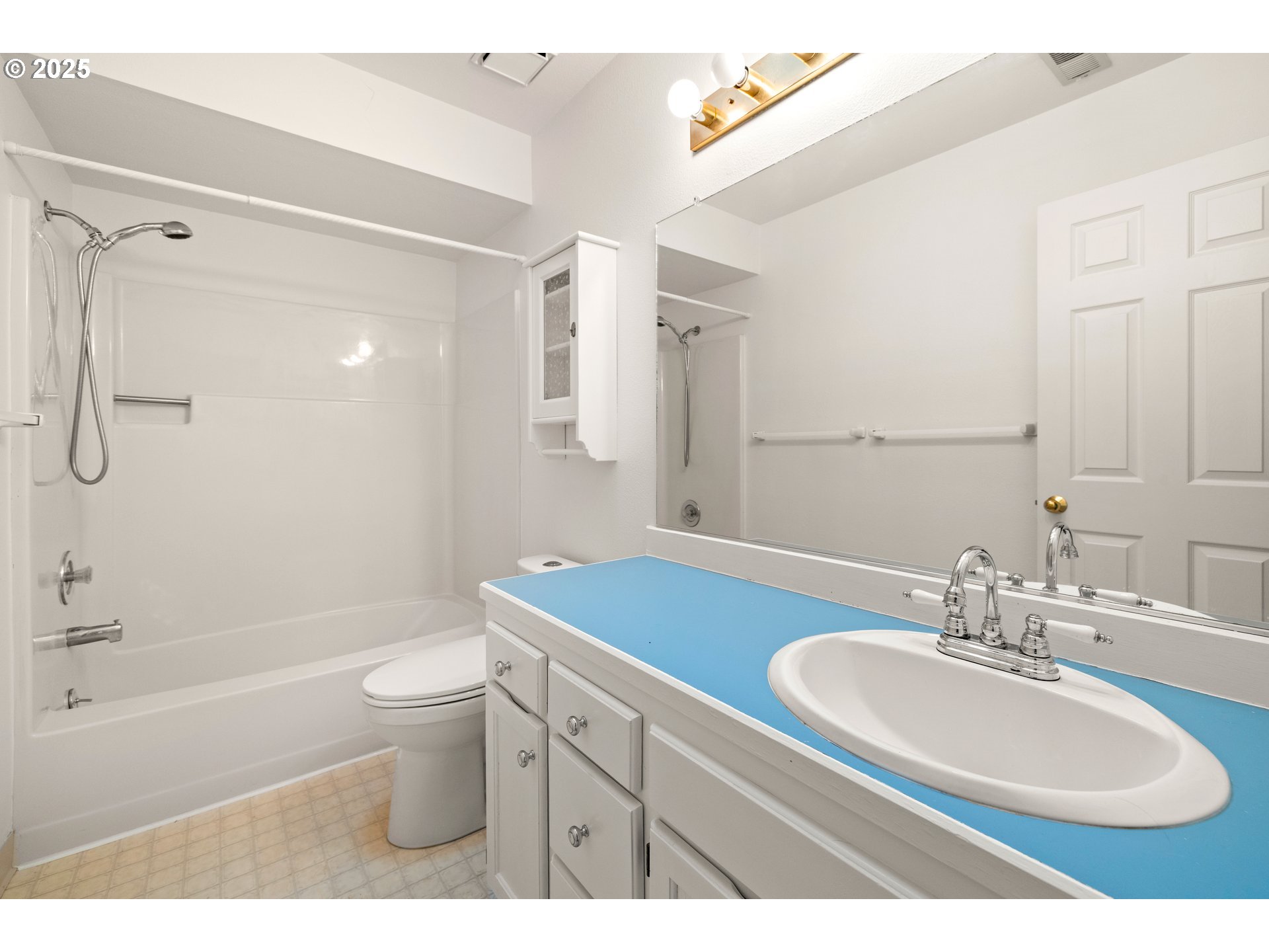 5393 Southwest Wichita Street Tualatin, OR 97062 - Photo 35 of 45 a bathroom with a sink toilet a mirror a bathtub and shower