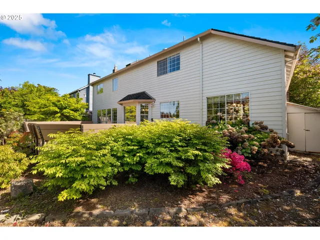 a view of a house with a flower garden