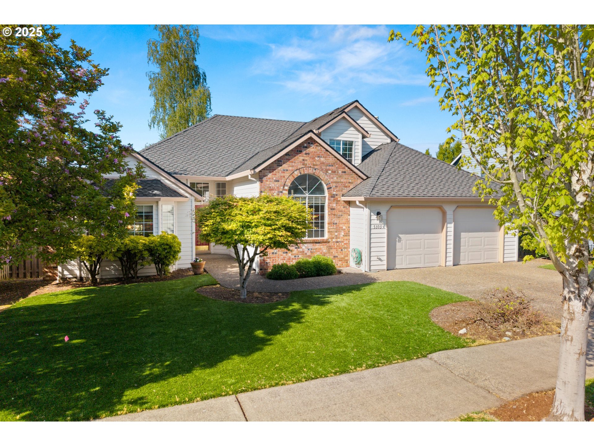 5393 Southwest Wichita Street Tualatin, OR 97062 - Photo 6 of 45 a front view of a house with a yard and garage
