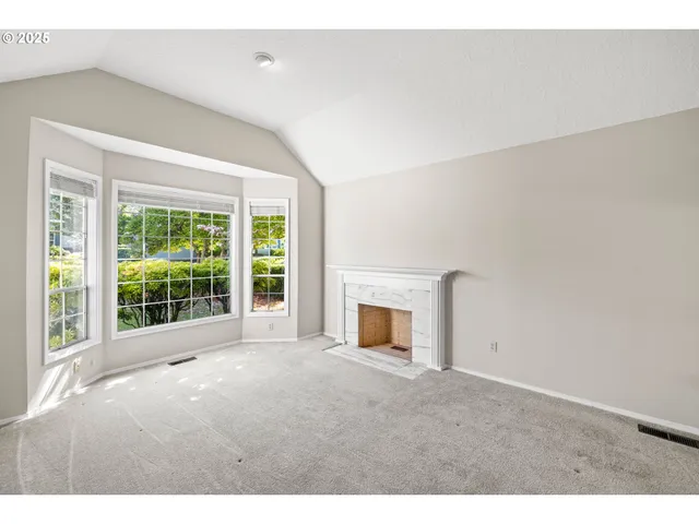 a view of empty room with a fireplace
