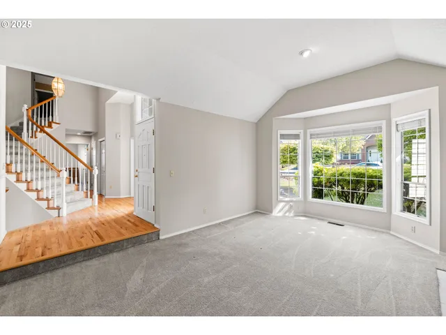 a backyard of a house with wooden floor and windows