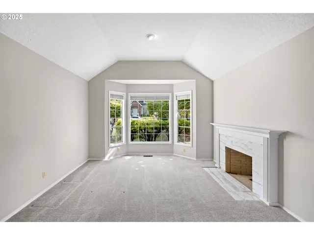 a view of empty room with a fireplace