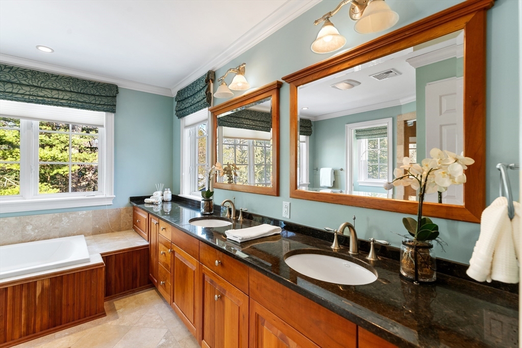 22 Fairbanks Road Lexington, MA 02421 - Photo 28 of 41 a bathroom with a granite countertop sink and a large mirror