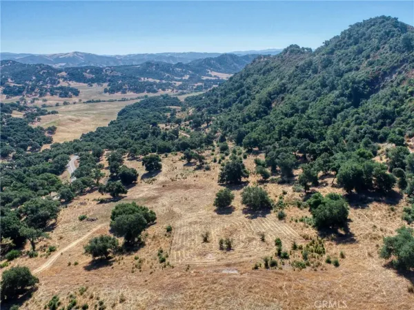 an aerial view of mountain with yard