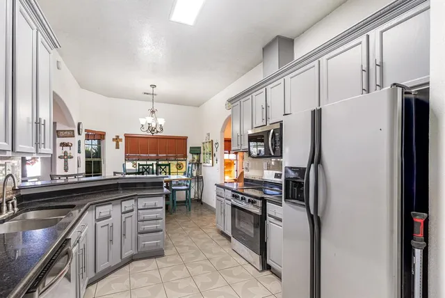 a kitchen with stainless steel appliances a refrigerator stove and sink