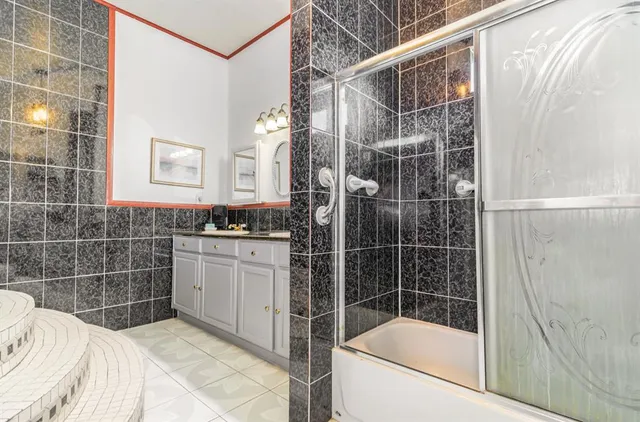 a bathroom with a shower and a sink