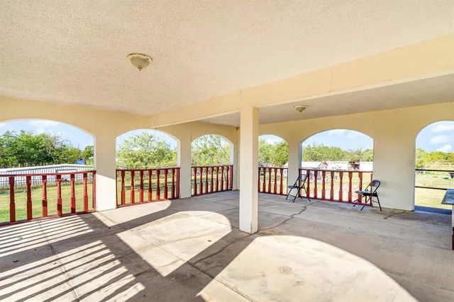 a view of a porch with two chairs and a table
