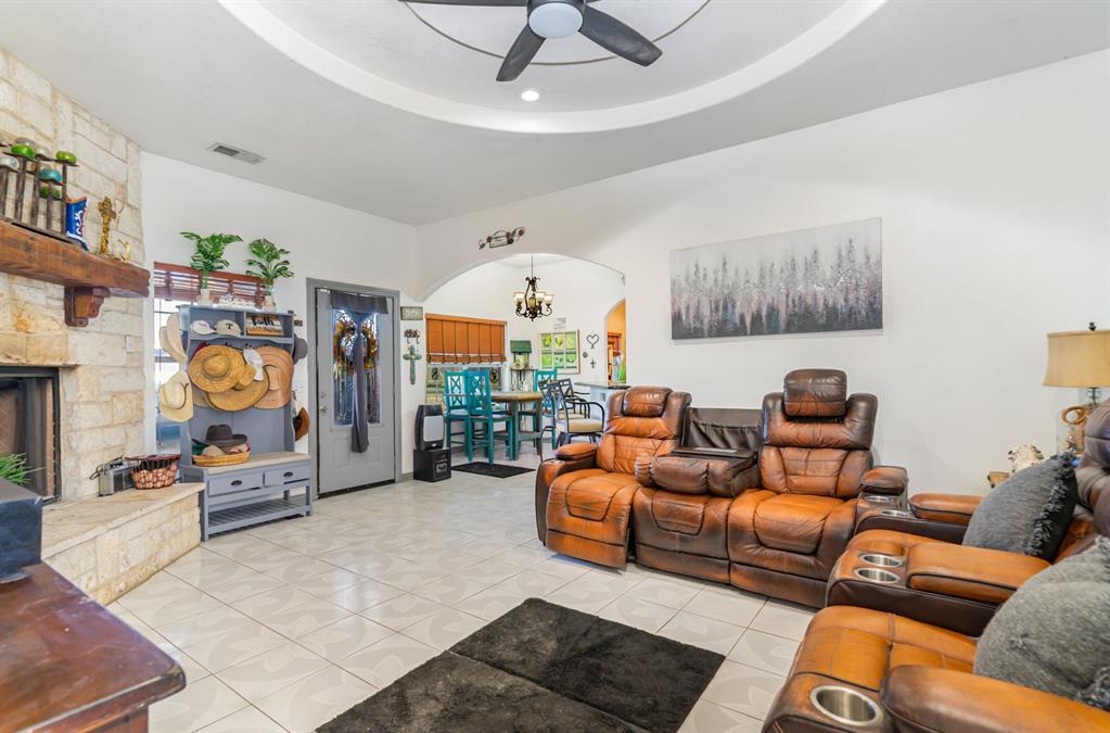 6524 Fair Road Kaufman, TX 75142 - Photo 6 of 33 a living room with furniture a fireplace and a chandelier