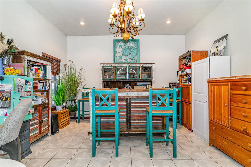 6524 Fair Road Kaufman, TX 75142 - Photo 8 of 33 a dining room filled with furniture and a chandelier