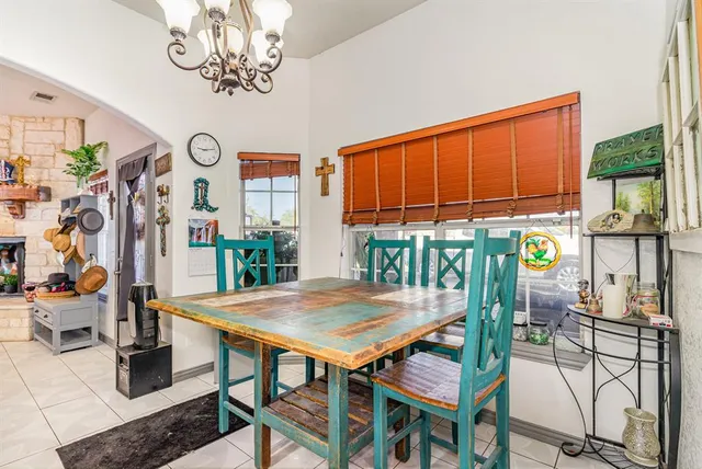 a view of a dining room with furniture a chandelier and wooden floor