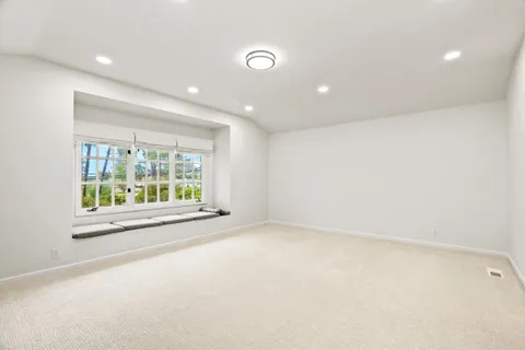 an empty room with entrance and windows