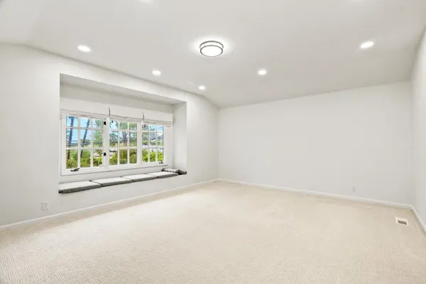 an empty room with entrance and windows