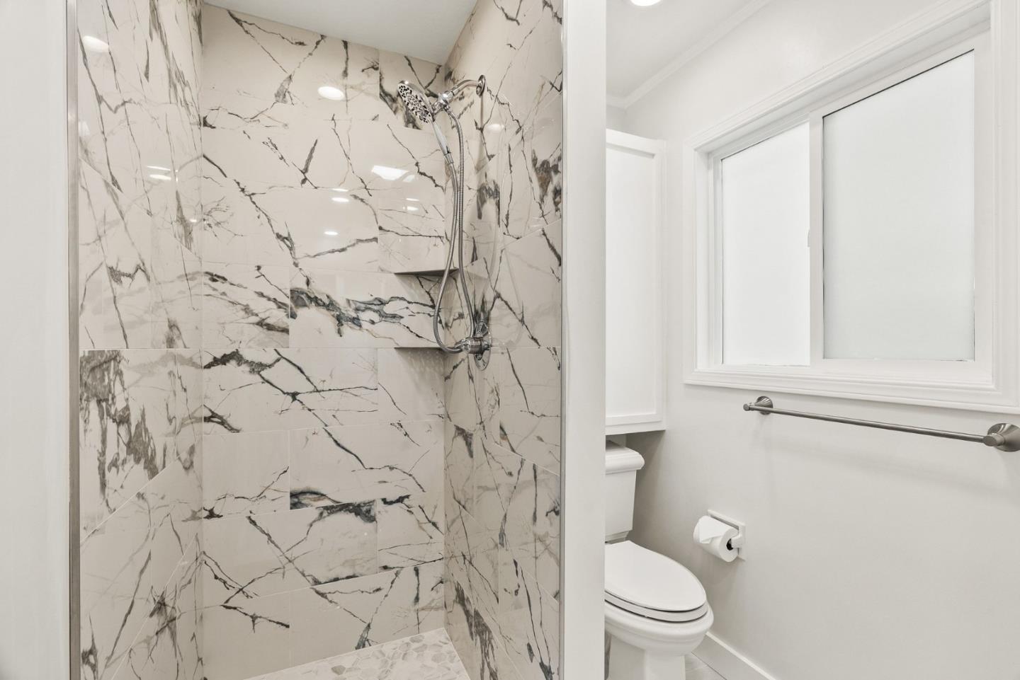 3041 Bird Rock Road Pebble Beach, CA 93953 - Photo 21 of 35 a bathroom with a toilet and a shower curtain