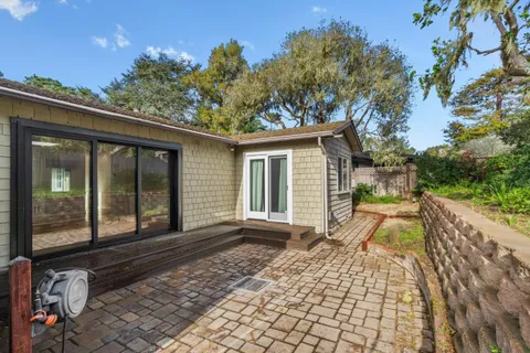 a view of a house with a backyard