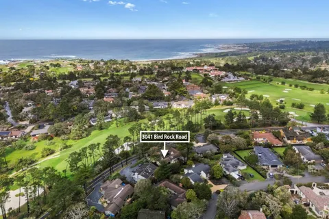 an aerial view of residential building with outdoor space and trees