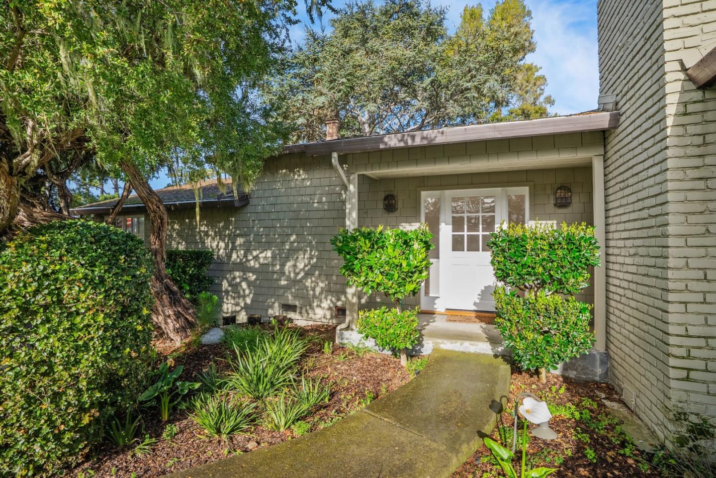 3041 Bird Rock Road Pebble Beach, CA 93953 - Photo 6 of 35 a front view of a house with garden