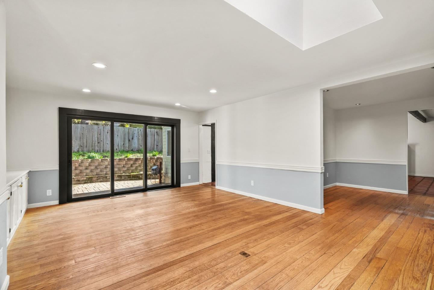 3041 Bird Rock Road Pebble Beach, CA 93953 - Photo 10 of 35 a view of an empty room with wooden floor and a window