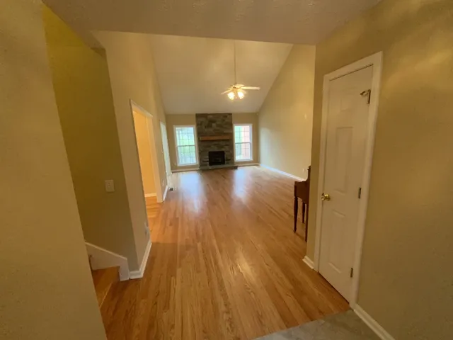 a view of a hallway with wooden floor