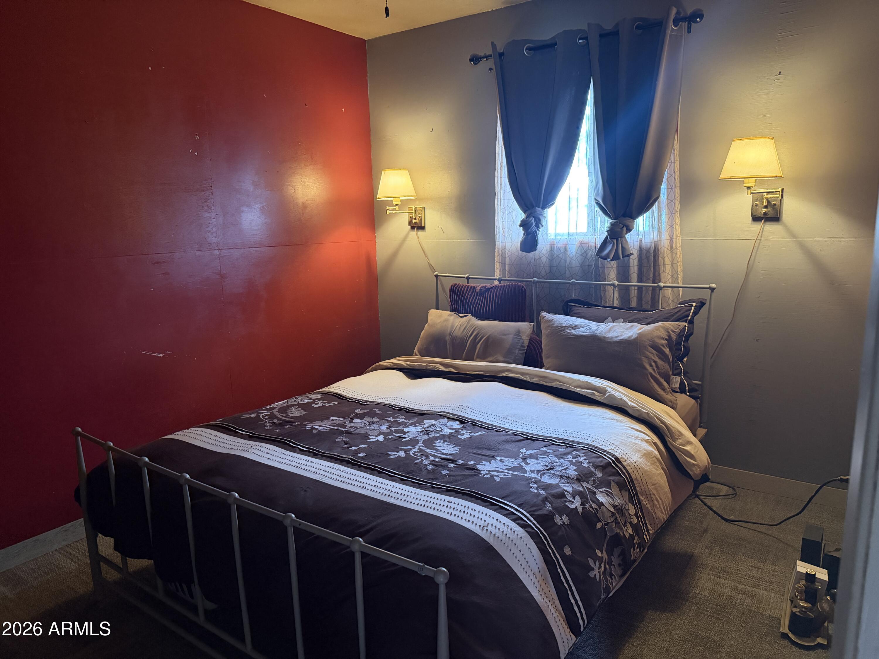 1 Hideaway Road Ash Fork, AZ 86320 - Photo 15 of 45 a bedroom with a bed a mirror and lamp