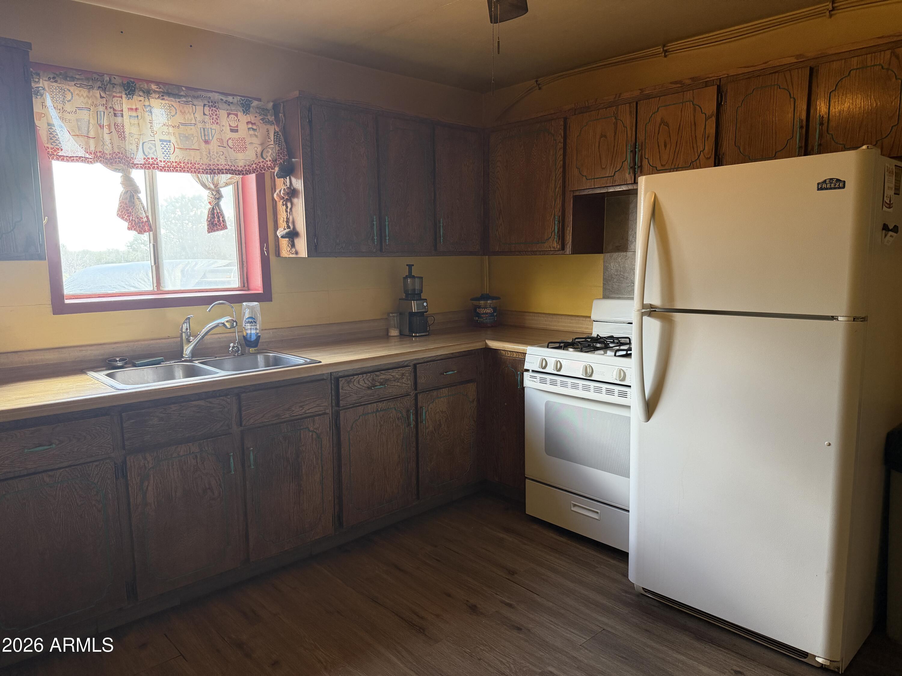 1 Hideaway Road Ash Fork, AZ 86320 - Photo 6 of 45 a white refrigerator freezer sitting inside of a kitchen with stainless steel appliances granite countertop a refrigerator sink and cabinets