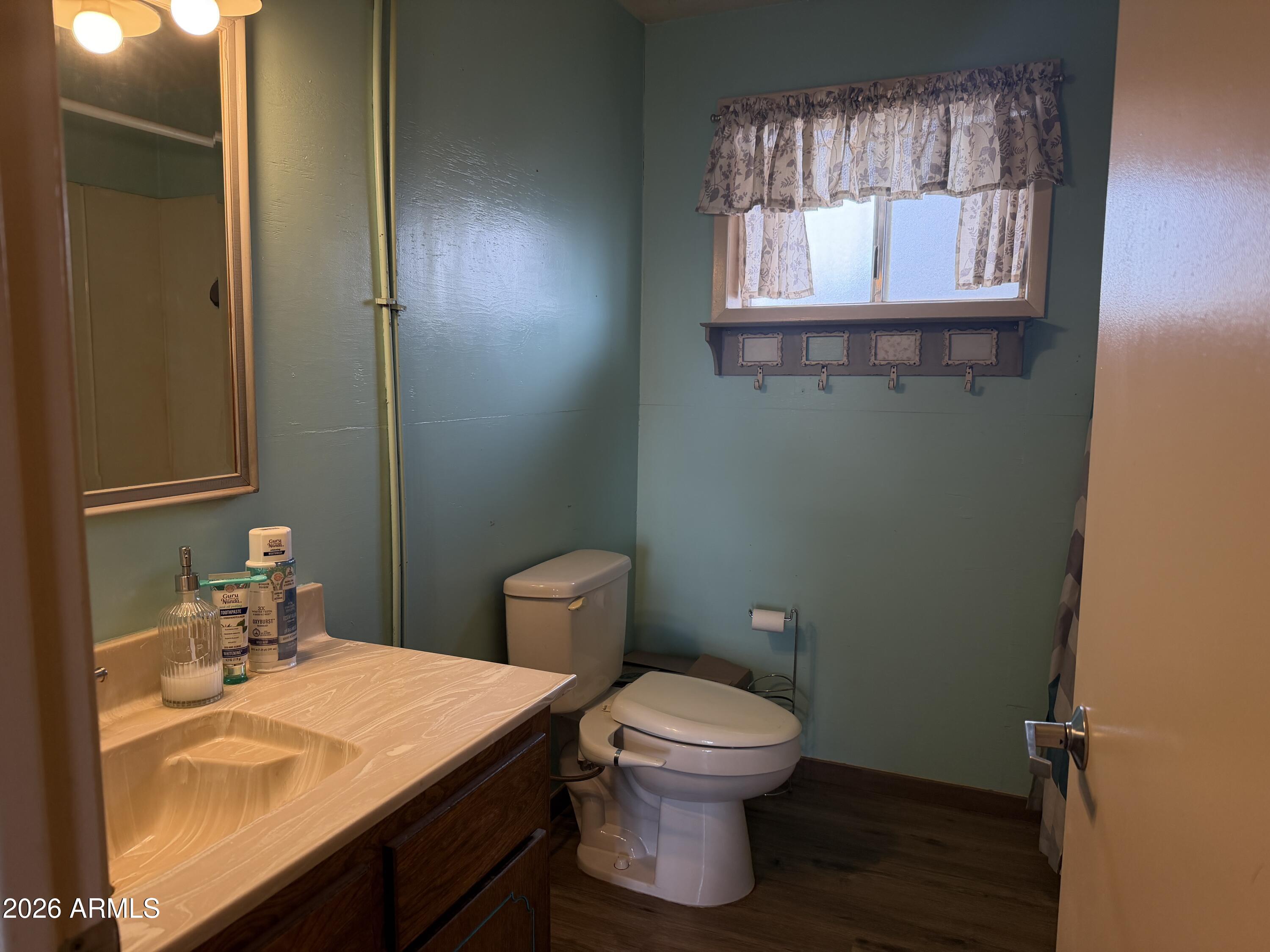 1 Hideaway Road Ash Fork, AZ 86320 - Photo 9 of 45 a bathroom with a toilet sink and mirror