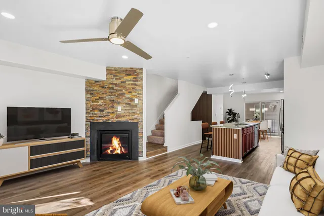 a living room with furniture and a fireplace