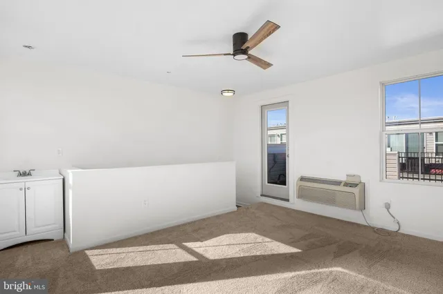 a view of terrace with lawn chairs and iron fence