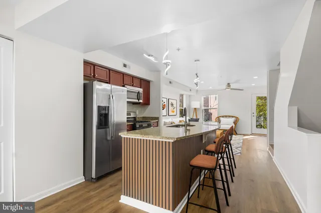 a kitchen with stainless steel appliances a sink stove and refrigerator