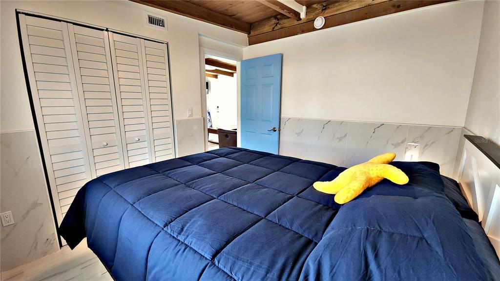 Undisclosed Address Englewood, FL 34223 - Photo 11 of 24 a bedroom with a bed and painting on the wall