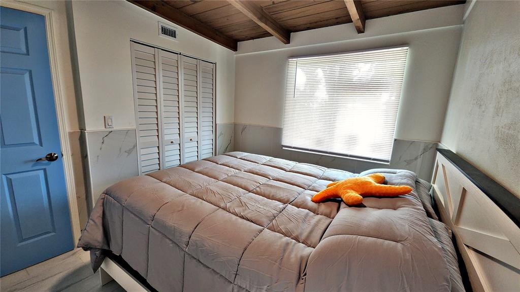 Undisclosed Address Englewood, FL 34223 - Photo 12 of 24 a bedroom with a bed and window