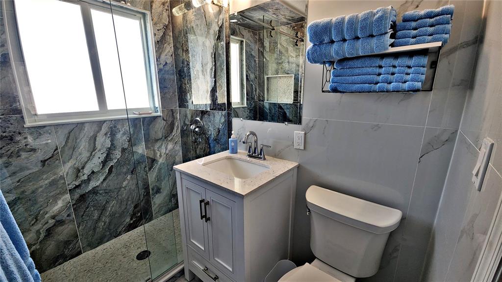 Undisclosed Address Englewood, FL 34223 - Photo 13 of 24 a bathroom with a toilet sink and mirror