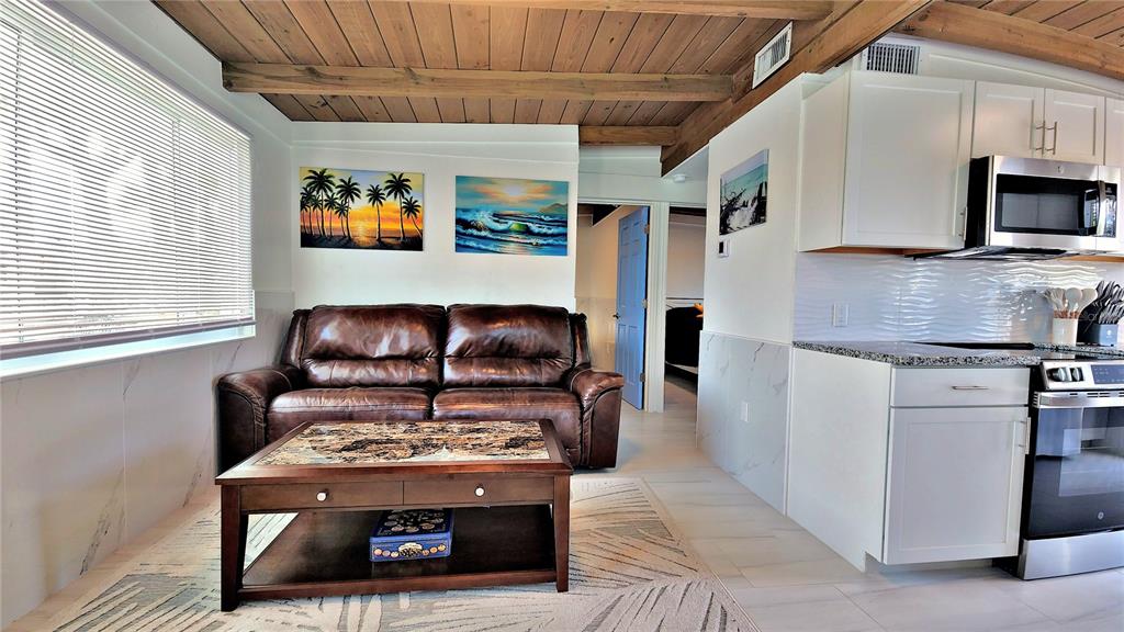 Undisclosed Address Englewood, FL 34223 - Photo 6 of 24 a living room with furniture and a fireplace