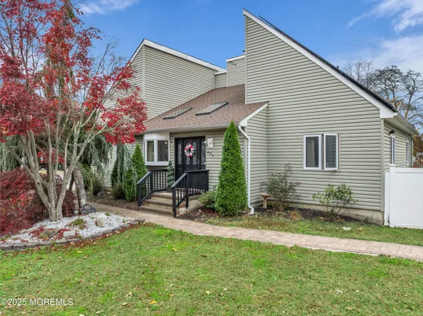 a view of a house with a yard and sitting area