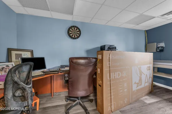 a view of workspace with wooden floor windows