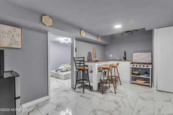 a dining room with furniture and a view of kitchen