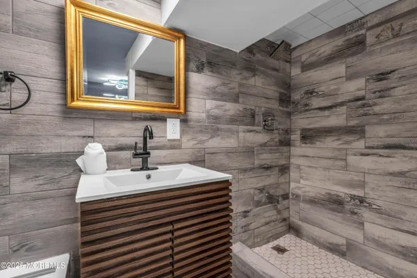 a bathroom with a sink a mirror and a shower