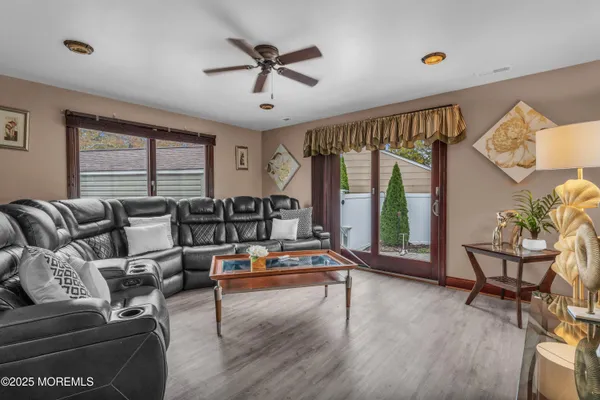 a living room with furniture gym equipment and a large window