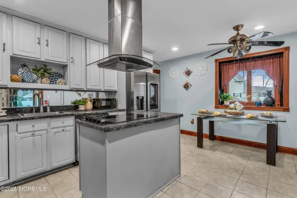 a kitchen with stainless steel appliances granite countertop a sink and cabinets