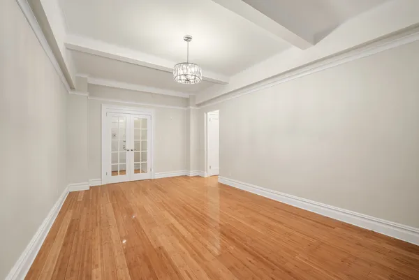 a living room with furniture potted plant and window