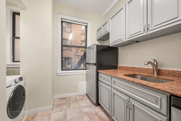 a kitchen with stainless steel appliances granite countertop a stove and a sink