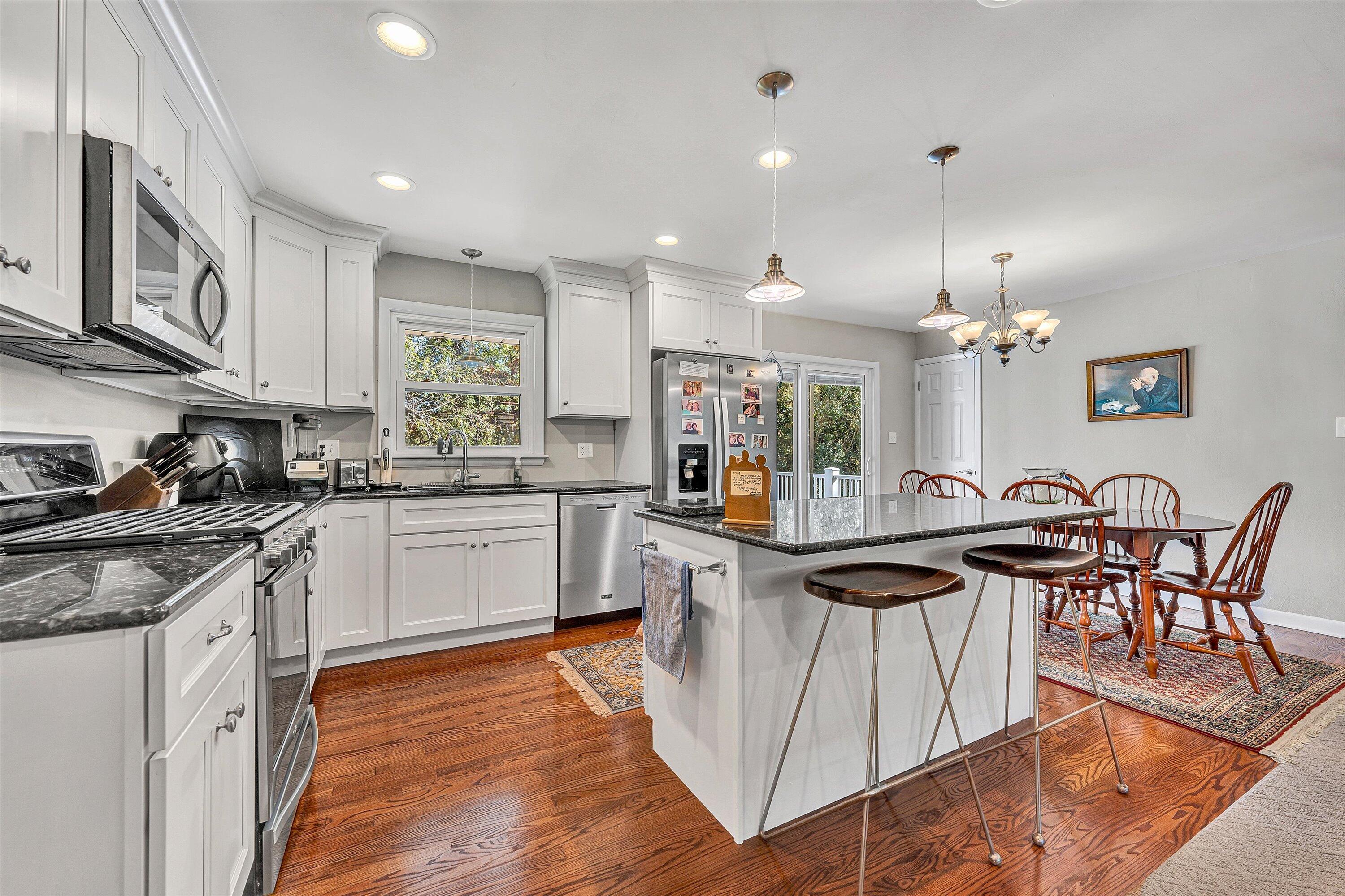 2312 Kipling Street Southwest Roanoke, VA 24018 - Photo 18 of 52 a kitchen with stainless steel appliances granite countertop wooden cabinets a stove top oven a sink and dishwasher