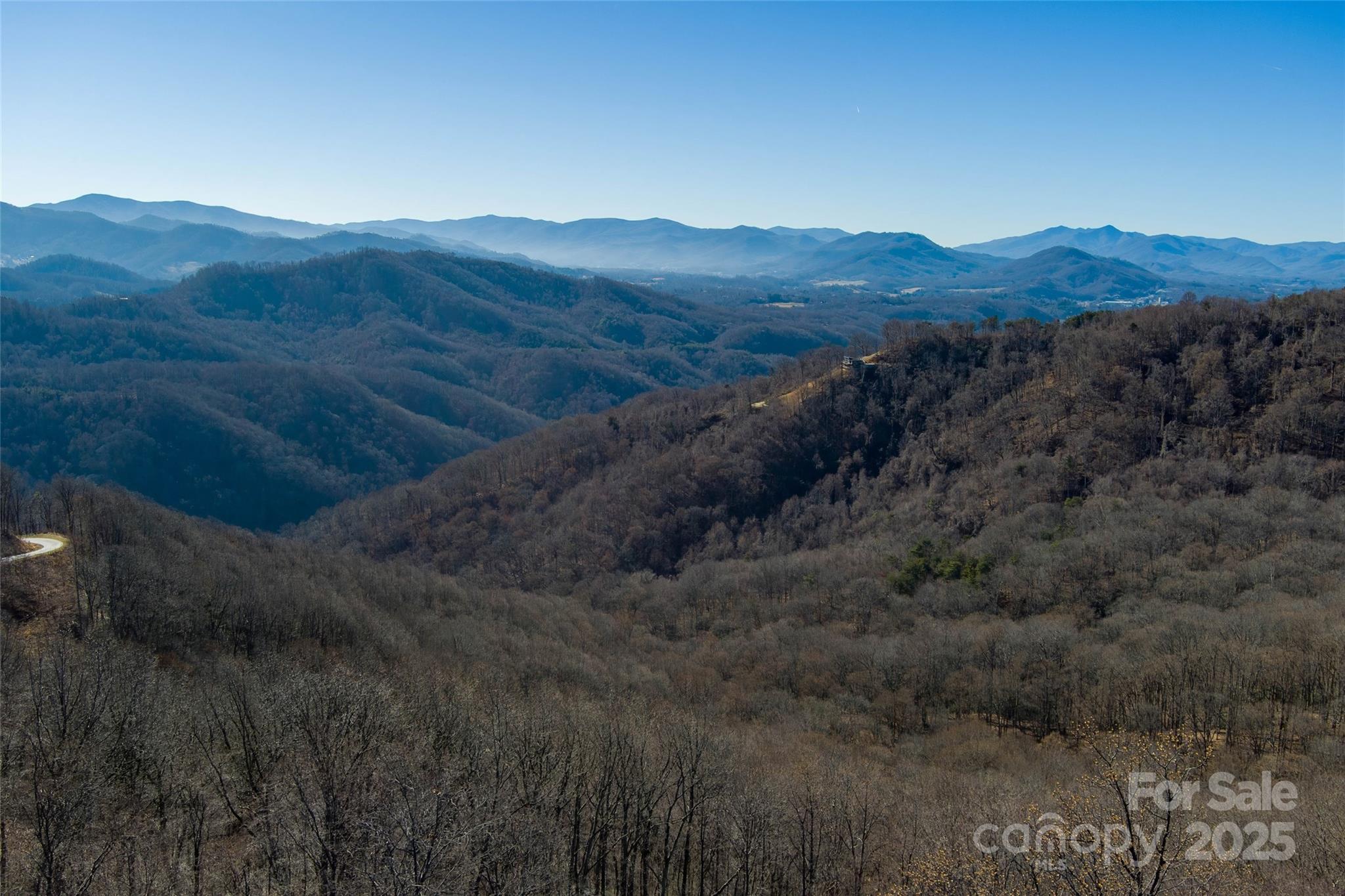 a view of a mountain range with trees in the background