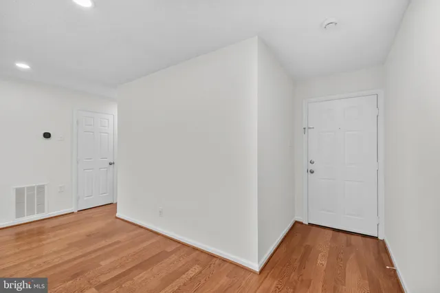 a view of a room with wooden floor