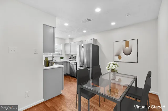 a kitchen with refrigerator and cabinets